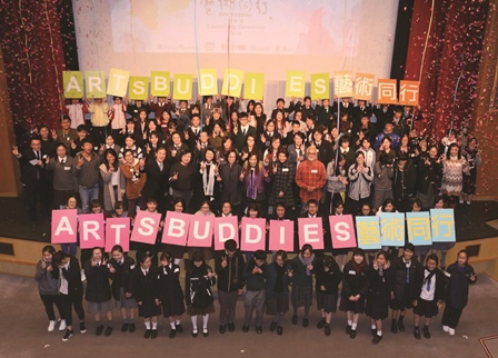 Guests and participants hold up placards for a group photo to kick off the Arts Buddies project.