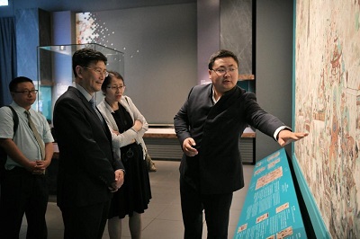 敦煌研究院的导赏员向上海博物馆馆长介绍敦煌壁画内容。