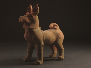 Red pottery dog with painted decoration