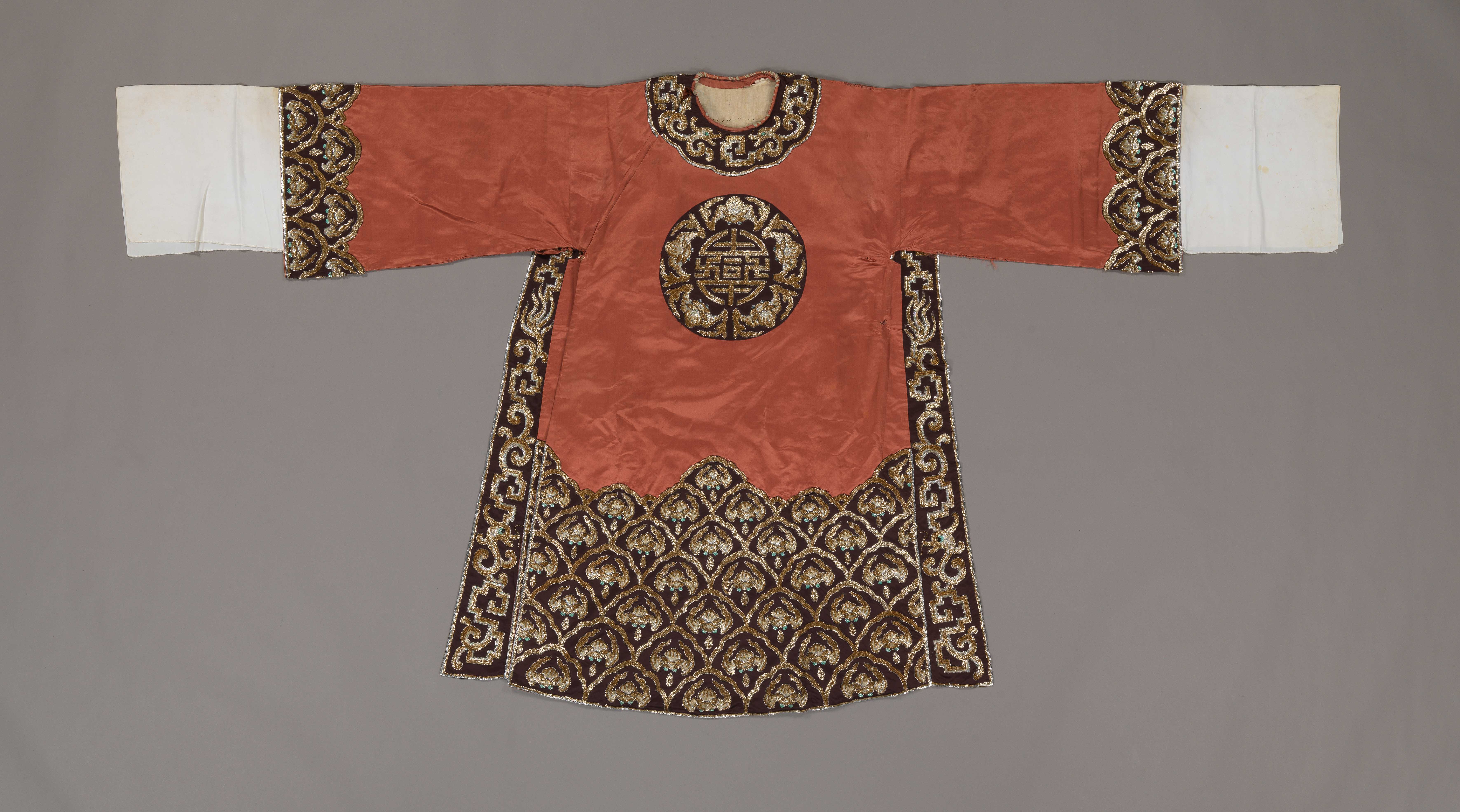 Brown man's python ceremonial robe with gold and silver sequins worn by Leung Sing Por